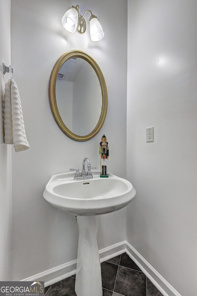 bathroom featuring tile patterned flooring and sink