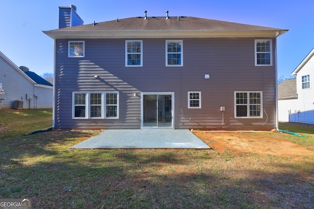 rear view of house featuring a yard, a patio, and central air condition unit