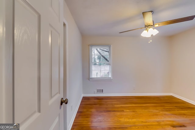 unfurnished room featuring hardwood / wood-style floors and ceiling fan