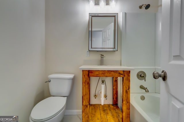 bathroom with toilet, sink, and a tub