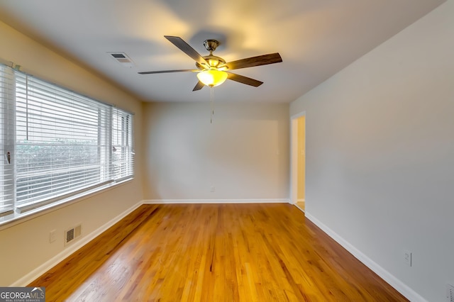 unfurnished room with ceiling fan and light hardwood / wood-style flooring