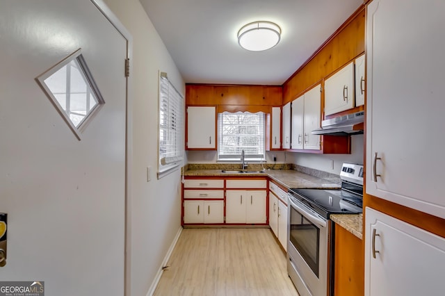 kitchen with sink, light hardwood / wood-style flooring, white cabinets, and stainless steel range with electric stovetop