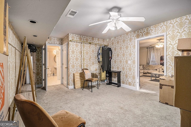 interior space with ceiling fan and light colored carpet