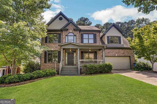 view of front of property with a porch, a garage, and a front lawn