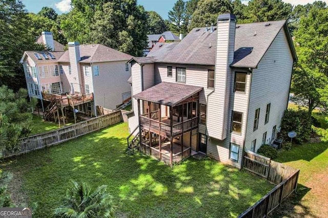 back of house with a lawn and a deck