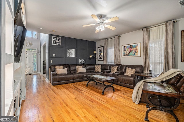 living room featuring ceiling fan and light wood-type flooring