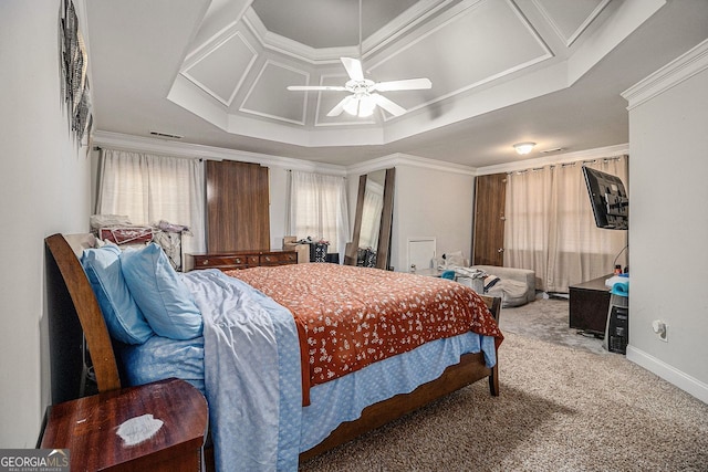 carpeted bedroom with a tray ceiling, ceiling fan, and ornamental molding