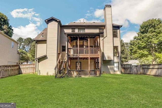 rear view of property featuring a lawn