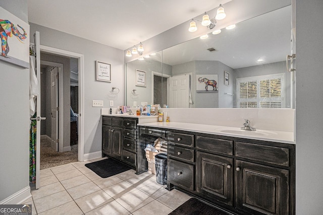 bathroom with tile patterned floors and vanity