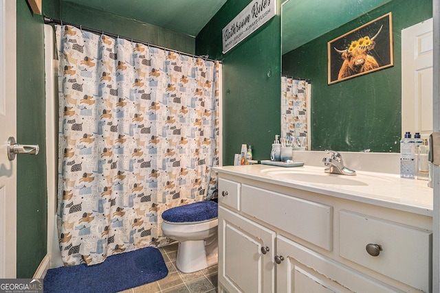 bathroom featuring tile patterned floors, vanity, and toilet