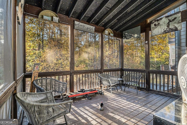 unfurnished sunroom featuring plenty of natural light and vaulted ceiling