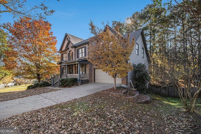 view of front of home with covered porch and a garage