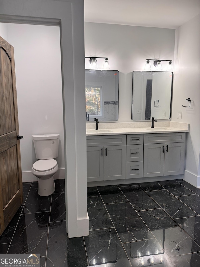 bathroom featuring vanity and toilet