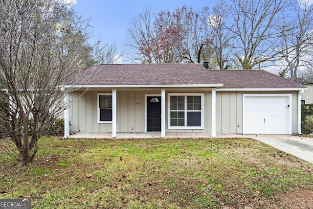 ranch-style house featuring a porch, a garage, and a front yard