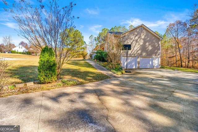 view of property exterior featuring a lawn and a garage