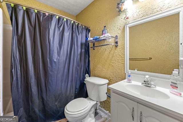 bathroom featuring vanity, curtained shower, toilet, and a textured ceiling