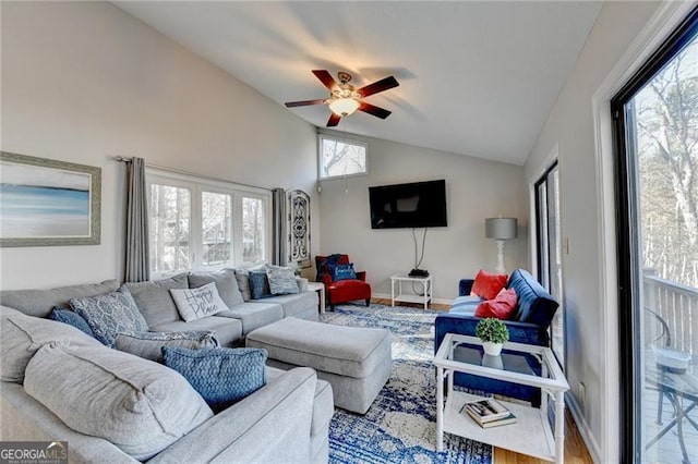 living room featuring hardwood / wood-style flooring, ceiling fan, and high vaulted ceiling