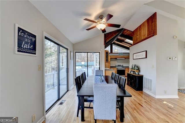 dining area with light wood-type flooring, lofted ceiling with beams, and ceiling fan