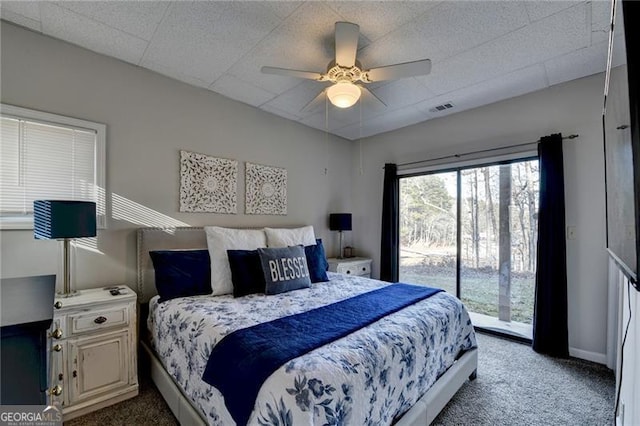 bedroom featuring carpet flooring, ceiling fan, a paneled ceiling, and access to outside