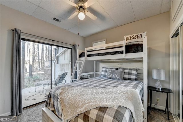 carpeted bedroom featuring a paneled ceiling and ceiling fan