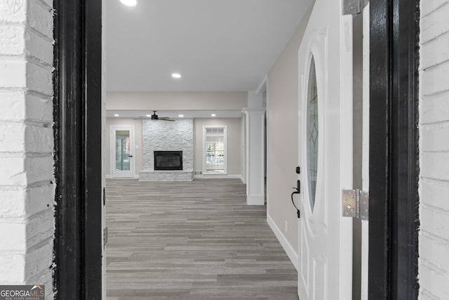 hallway with hardwood / wood-style floors and ornate columns