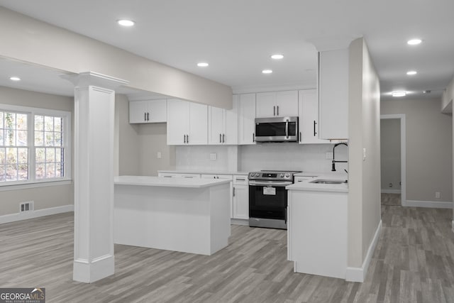 kitchen featuring light hardwood / wood-style floors, white cabinetry, sink, and appliances with stainless steel finishes