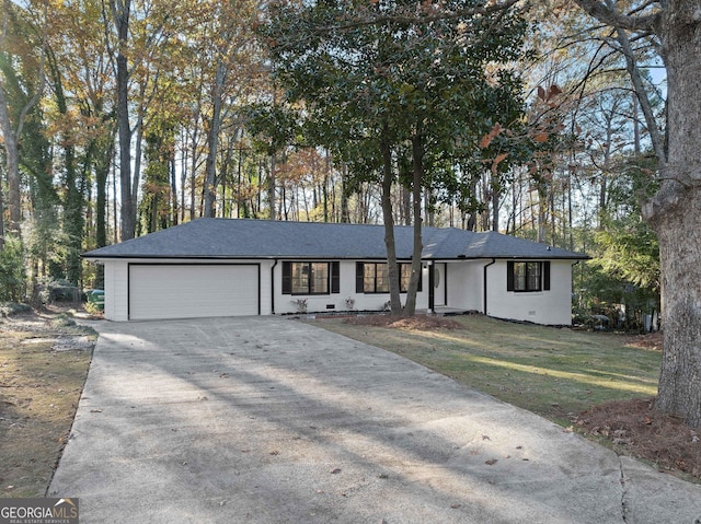 ranch-style home with a garage and a front lawn