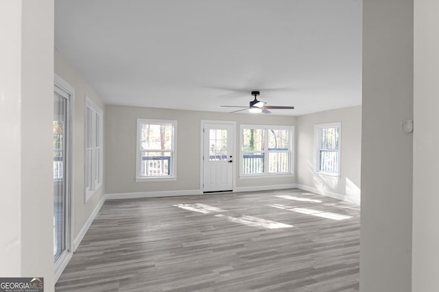 interior space featuring hardwood / wood-style floors and ceiling fan