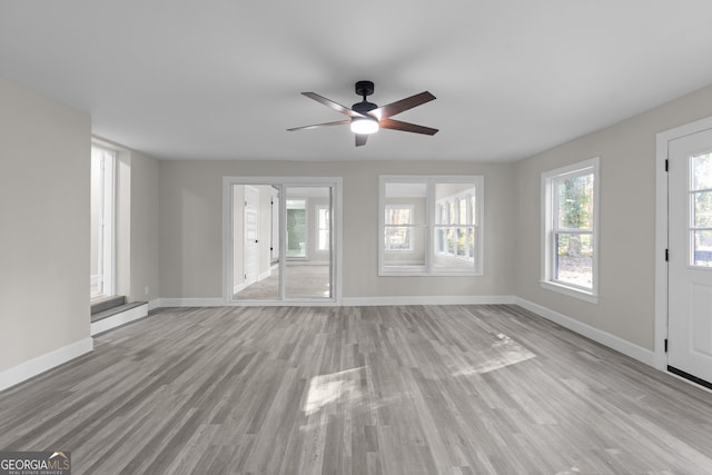 unfurnished living room with ceiling fan and light hardwood / wood-style flooring