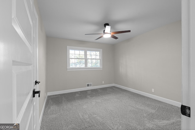 carpeted spare room with ceiling fan