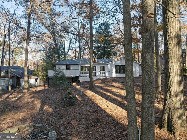 exterior space featuring an outbuilding and a deck