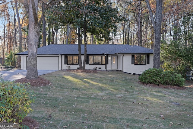 ranch-style home featuring a front yard and a garage