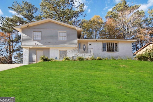 tri-level home with a front lawn