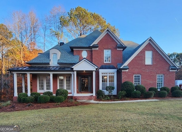 view of front of property with covered porch and a front yard