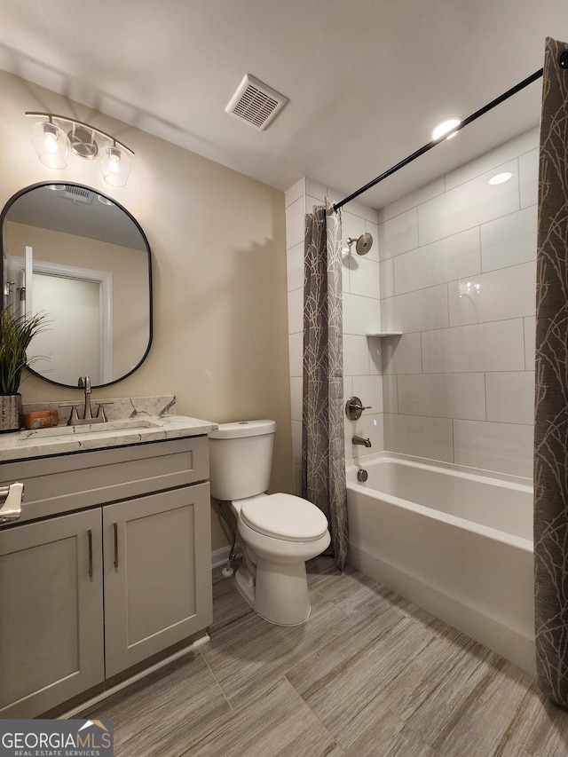 full bathroom with shower / bath combo with shower curtain, vanity, and toilet