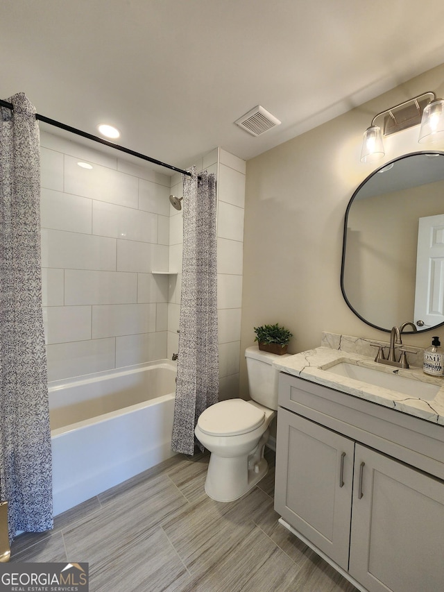 full bathroom featuring toilet, vanity, and shower / tub combo with curtain