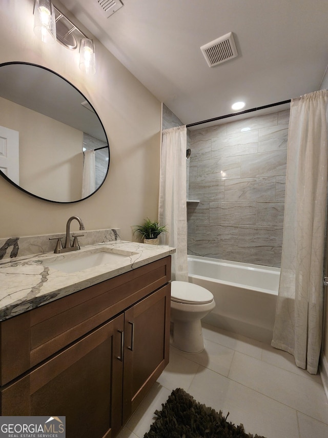 full bathroom featuring tile patterned flooring, vanity, toilet, and shower / bathtub combination with curtain