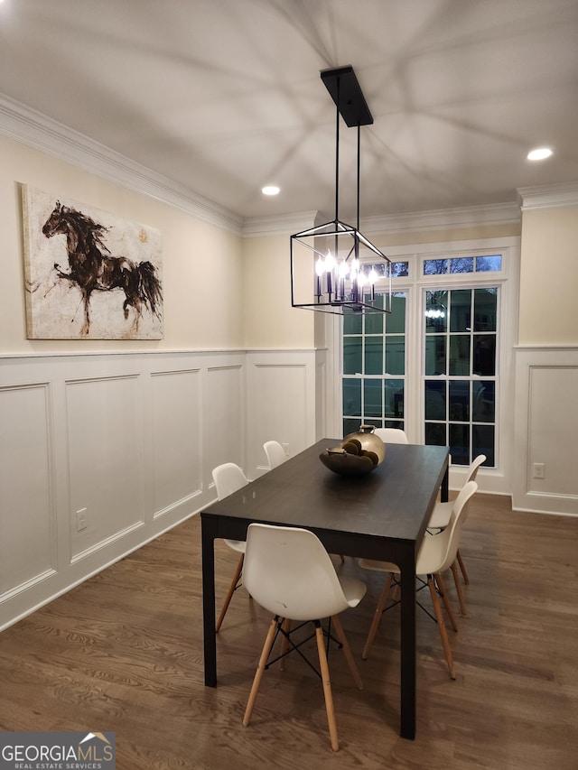 dining area with a chandelier, crown molding, and dark wood-type flooring