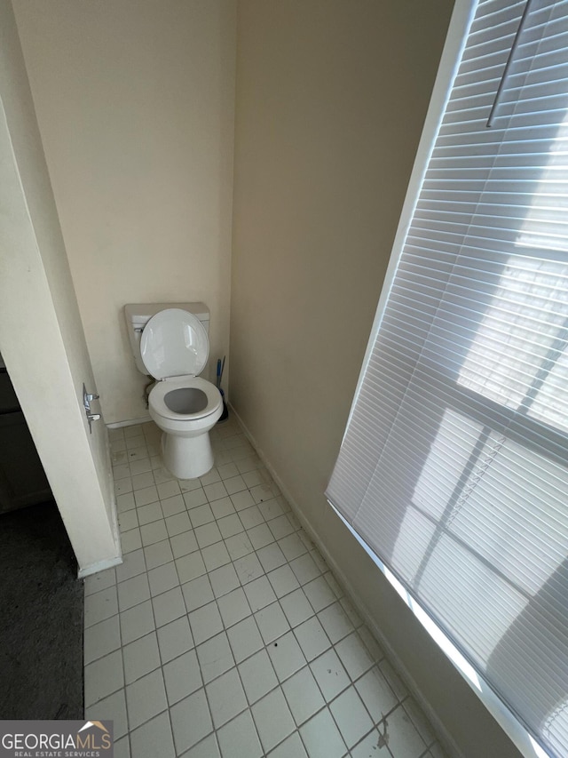 bathroom with toilet and tile patterned floors