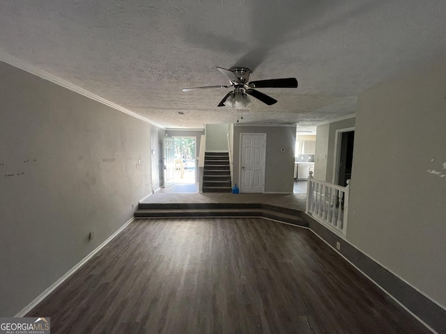 unfurnished room featuring ceiling fan, dark hardwood / wood-style floors, a textured ceiling, and ornamental molding