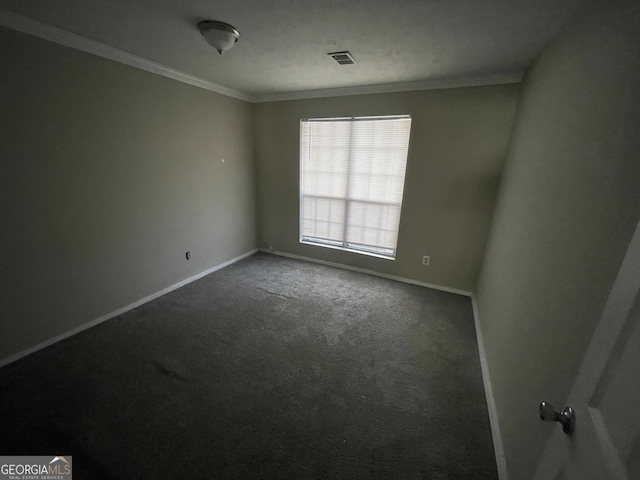 carpeted spare room featuring crown molding