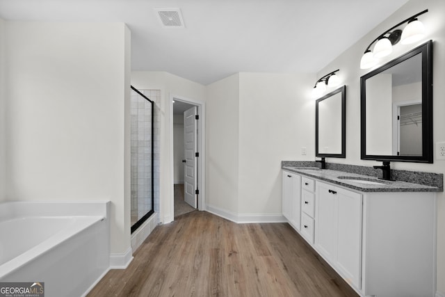 bathroom featuring vanity, hardwood / wood-style flooring, and separate shower and tub