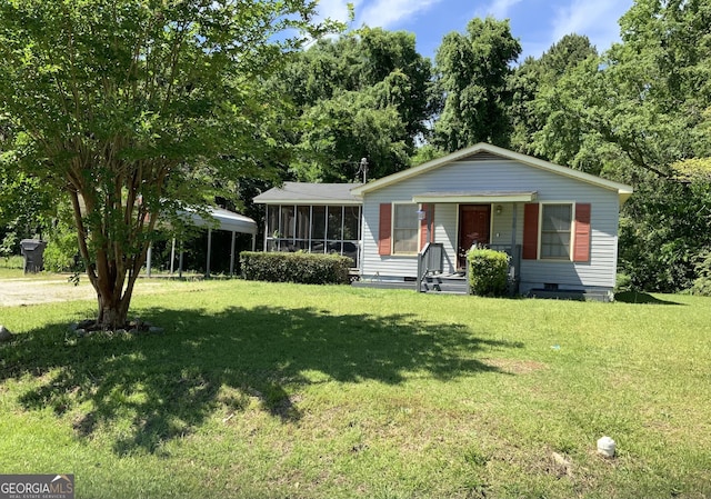 view of front of property featuring a sunroom, a front yard, and crawl space