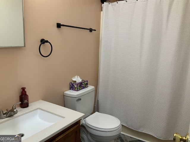 bathroom featuring a shower with curtain, vanity, and toilet