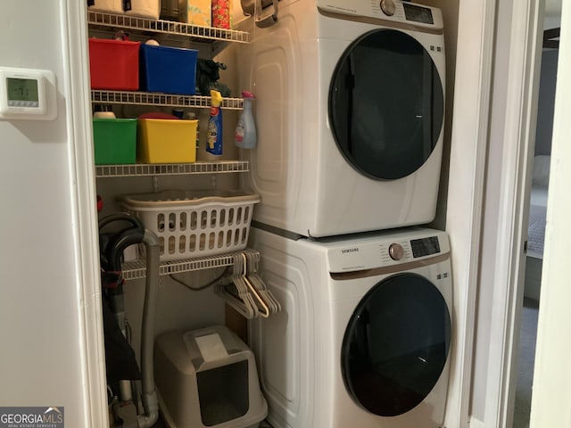 clothes washing area with stacked washer and dryer