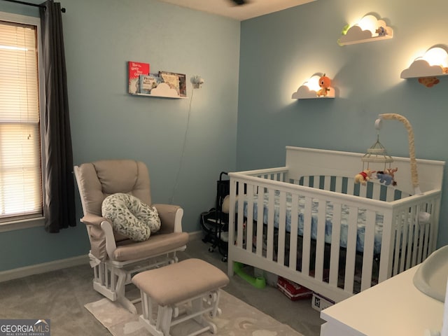 bedroom with carpet flooring and a crib