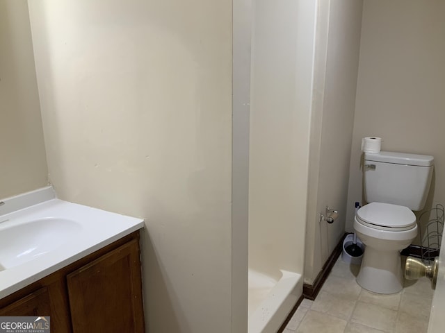 bathroom featuring tile patterned floors, vanity, toilet, and walk in shower