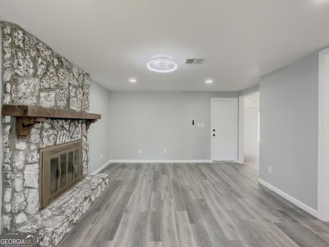 unfurnished living room featuring light hardwood / wood-style floors and a fireplace