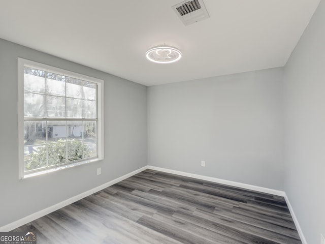 unfurnished room with wood-type flooring