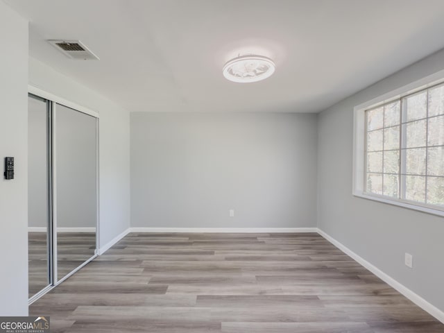 unfurnished room featuring light hardwood / wood-style floors